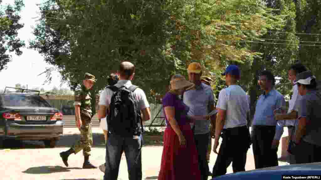 Военнослужащий внутренних войск проходит мимо сторонников заключенного оппозиционного политика Владимира Козлова, приехавших в поселок Заречный, чтобы поздравить Владимира Козлова с днем рождения.