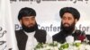 Muhammad Naeem (right), a spokesman for the Office of the Taliban of Afghanistan, speaks during the opening of the Taliban Afghanistan Political Office in Doha, Qatar, on June 18.