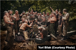 Ukrainian soldiers recreate Repin's painting in a photo made by Yuriy Bilak in the Donbas in spring of 2015. The conflict with Russia-backed separatists at the time was referred to as an "anti-terrorist operation" or ATO. The photographer titled the photo ATO Soldiers Write a Letter to the Sultan, that is, Putin."