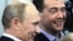 Prime Minister Vladimir Putin (left) and President Dmitry Medvedev try to smile as they visit the headquarters of the United Russia party after voting closed in Moscow on December 4.
