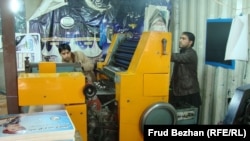Two employees at the Khurasan printing house in Kabul, Afghanistan. Business is currently booming in the local print industry. 