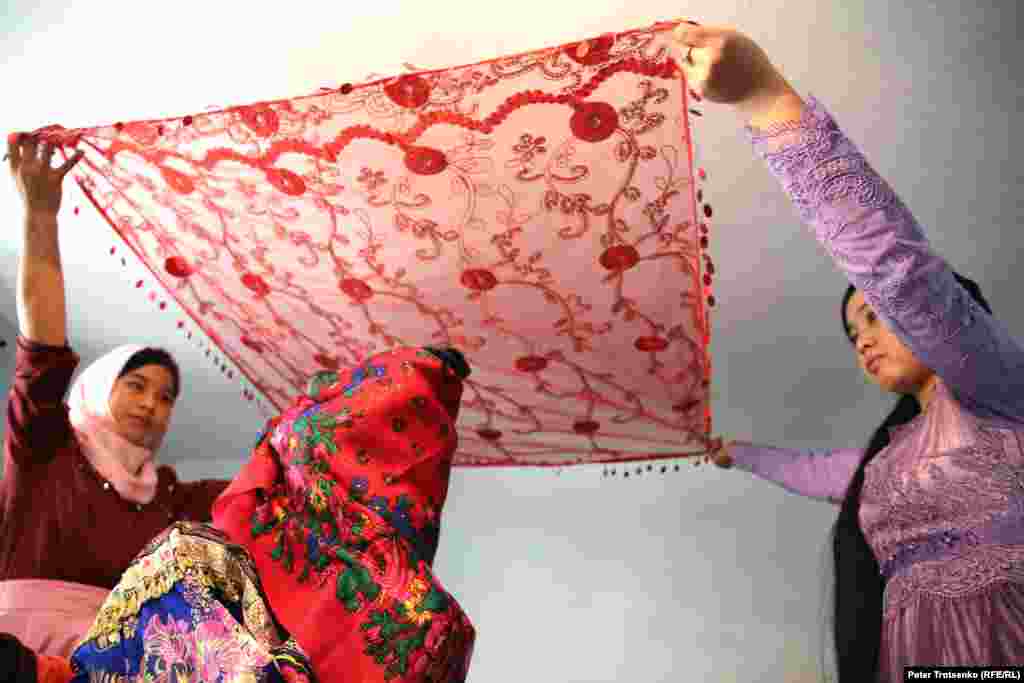 Перед тем, как покинуть родной дом, лицо невесты закрывают платком, поверх которого накидывается ещё один. Первый платок (из дома жениха) является символом того, что невеста становится членом новой семьи. Второй платок, согласно традиции, должен быть из дома матери.