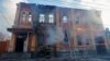 Firefighters work outside an office building destroyed by shelling in Donetsk, Ukraine, on December 5.