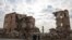 Syria - Syrians walk past one of Aleppo's destroyed structures near the northern city's historic citadel on December 5, 2024,