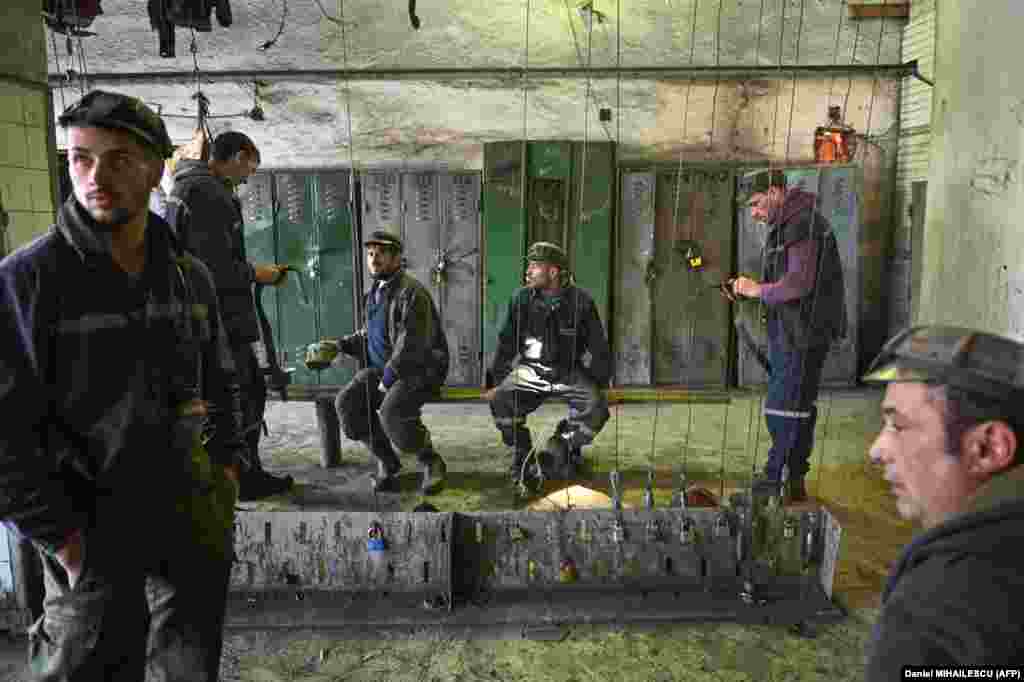 Miners stand in a locker room before starting their shift at the Lonea coal mine.