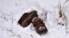 A pair of shoes belonging to a child lie in a snow-covered field in the northern Serbian village of Backi Vinogradi near the Hungarian border.