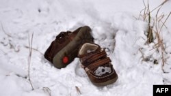 A pair of shoes belonging to a child lie in a snow-covered field in the northern Serbian village of Backi Vinogradi near the Hungarian border.