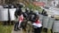 Riot police detain protesters carrying the red-and-white flag of the Belarusian opposition on November 8 in Minsk.