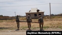 Kazakh sappers remove fragments of ammunition in the town of Arys following a series of deadly explosions there in June 2019. 