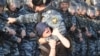 Policeman detains a female demonstrator during the March of Millions opposition protest in central Moscow. Demonstrators are protesting against Vladimir Putin’s new term as the Russian president.