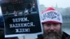 One of the tens of thousands of Moscow protesters holds a sign saying: "We believe, we hope, we wait!" His hat says: "Russian without Putin" 2012. 