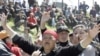 Люди скандируют лозунги во время митинга в селе Нижняя Алаарча близ Бишкека, 20 апреля 2010 года.