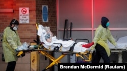 U.S. -- Paramedics bring a patient into the emergency center at Maimonides Medical Center during the outbreak of the coronavirus disease (COVID19) in the Brooklyn borough of New York, U.S., April 14, 2020.