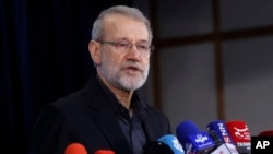 Ali Larijani talks to reporters after registering his name as a candidate for the June 2024 presidential elections in Tehran, on May 31, 2024. 