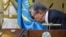 Kazakhstan - Acting President of Kazakhstan Kassym-Jomart Tokayev kisses a flag as he takes part in a swearing-in ceremony during a joint session of the houses of parliament in Astana, Kazakhstan March 20, 2019. Kazakh Presidential Press Service/Handout v