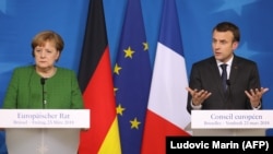 German Chancellor Angela Merkel (left) and French President Emmanuel Macron called for an EU solution (file photo)