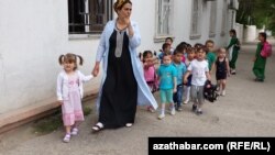 Çagalar bagynyň terbiýeçisi we körpeler. Arhiwden alnan surat