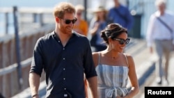 Британ ханзаадасы Гарри менен жубайы Меган Маркл. 