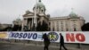 People walk past the Serbian parliament building in central Belgrade.
