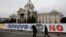 People walk past the Serbian parliament building in central Belgrade.