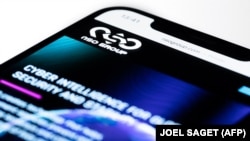 FRANCE-ISRAEL-SECURITY-SPYWARE-PEGASUS -- This studio photographic illustration shows a smartphone with the website of Israel's NSO Group which features 'Pegasus' spyware, on display in Paris on July 21, 2021.