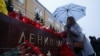 A woman lays flowers for the victims of the St. Petersburg blast by the Kremlin walls in Moscow.