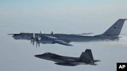 A Russian Tu-142 maritime reconnaissance aircraft (top) is intercepted near the Alaska coastline. (file photo)