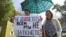 A woman holds a placard reading, "You can't shut up everyone!" as journalists and supporters take part in a protest against the "foreign agent" law in central Moscow on September 4.