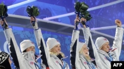 Лыжницы сборной Норвегии празднуют победу в эстафете