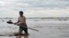 A man wades through flooding on April 25 after heavy downpours triggered flashfloods in Sheberghan, Afghanistan.