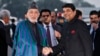 Afghan President Hamid Karzai (left) shakes hands with Indian Minister of State for Home Affairs R.P.N Singh upon his arrival at the airport in New Delhi on December 12.
