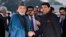 Afghan President Hamid Karzai (left) shakes hands with Indian Minister of State for Home Affairs R.P.N Singh upon his arrival at the airport in New Delhi on December 12.