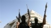 Palestine - Hamas fighters tot their arms as they stand in front of the pro-Fatah Palestinian Intelligence Security compound in Gaza City, 14Jun2007