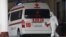 Armenia -- A medical worker clad in protecive gear and an ambulance parked at the entrance to Surp Grigor Lusavorich hospital, Yerevan, April 8, 2020.